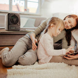 pureAir 3000 resting on the living room table. Ensuring a mother and child are breathing clean, sanitary, and fresh air.